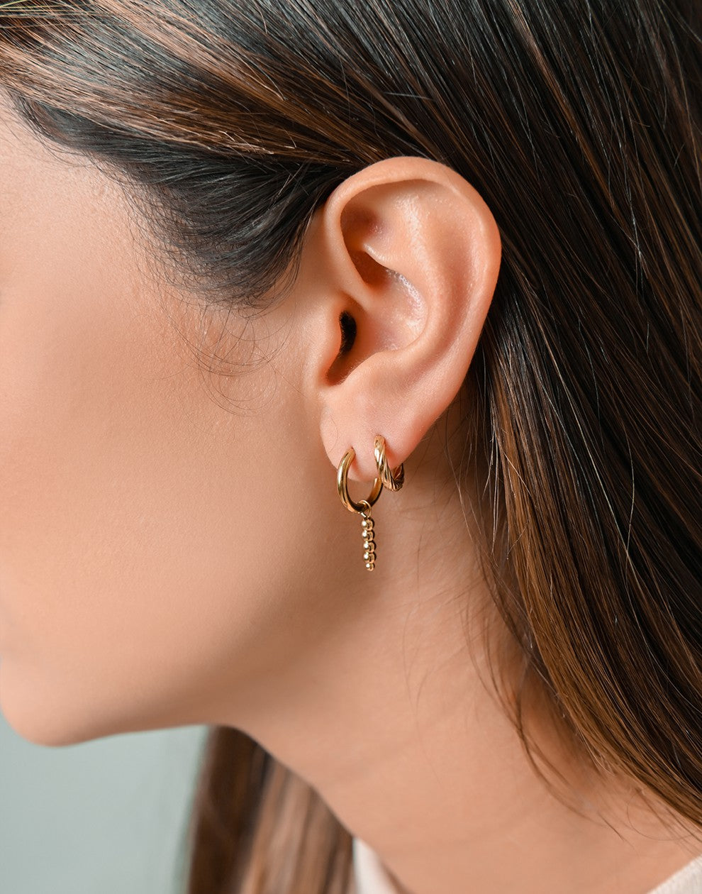 gold-colored twisted hoop earrings