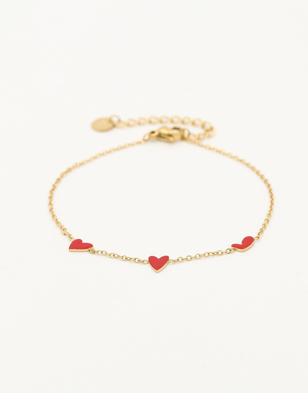 Armband speels hartjes rood goudkleurig