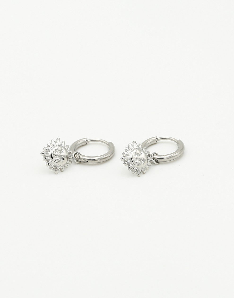 silver-colored sun earrings