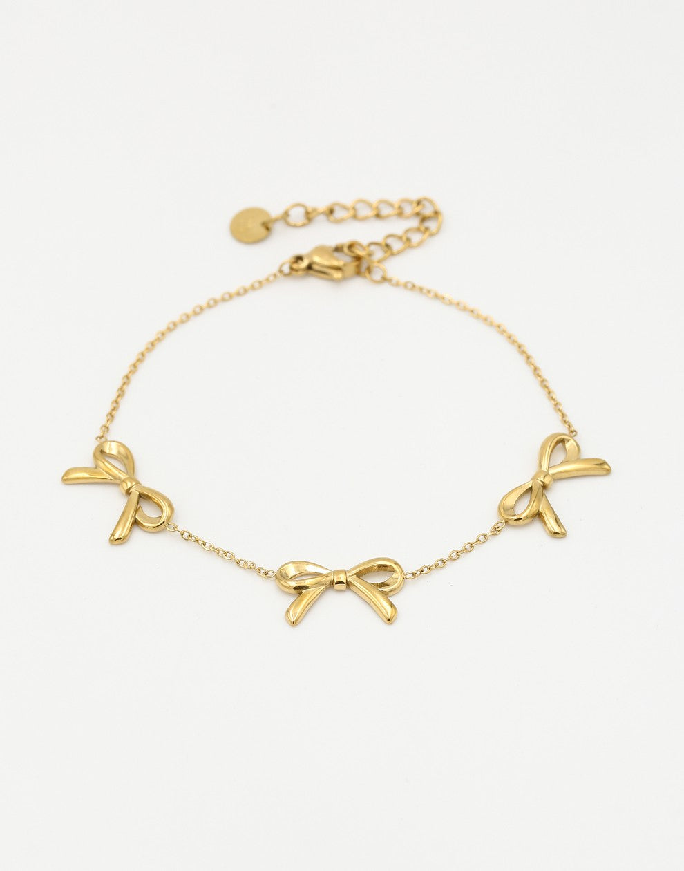 minimalist bracelet with 3 gold-colored bows