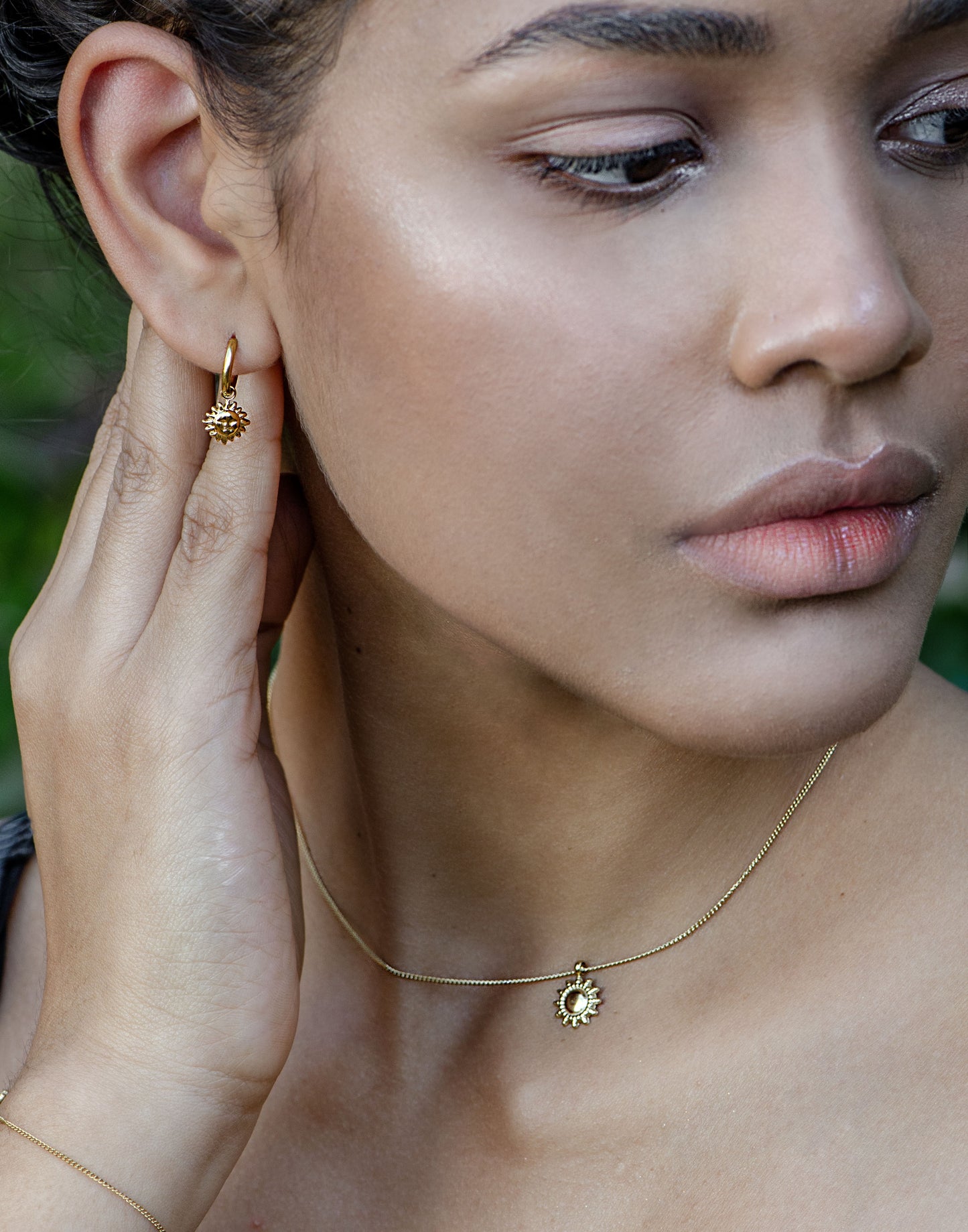 gold-colored sun earrings