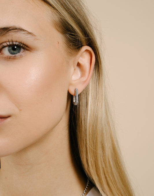 oval earrings with transparent silver-colored stones