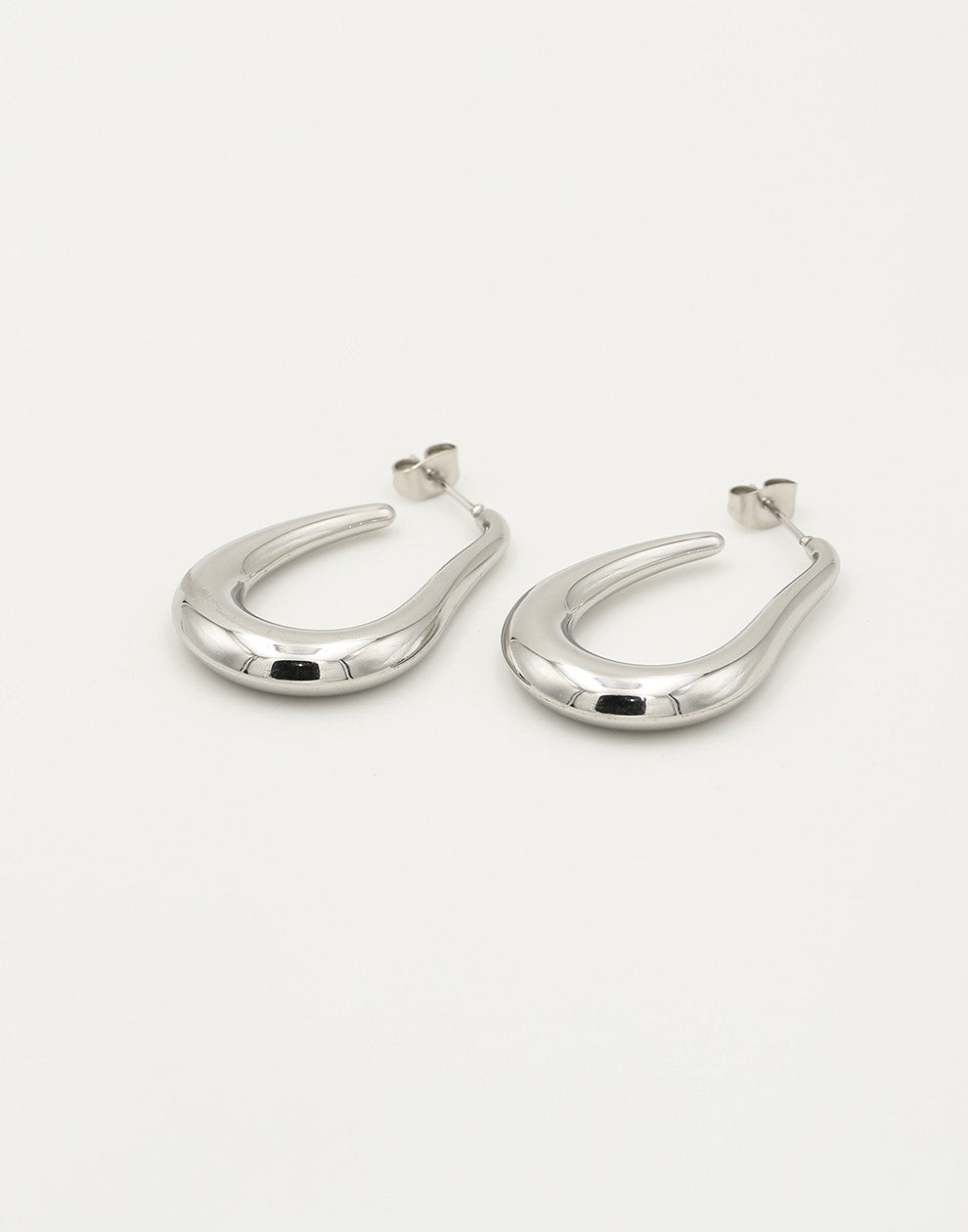 asymmetrical silver-colored earrings