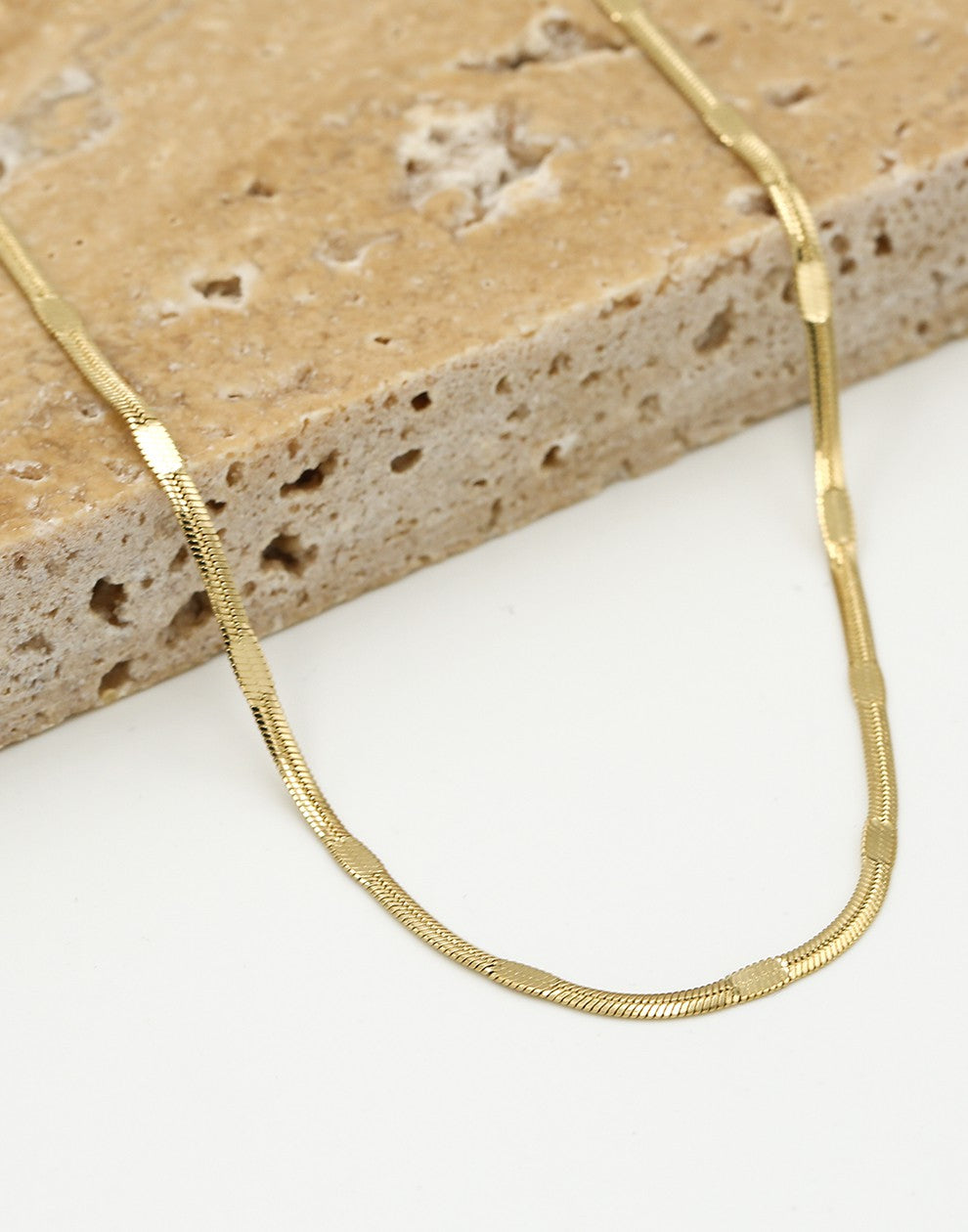 Flat gold-colored chain