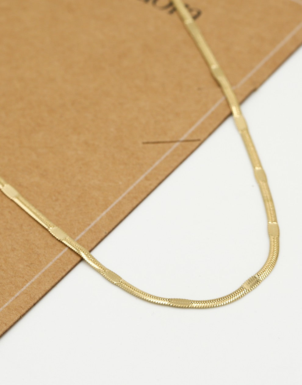 Flat gold-colored chain