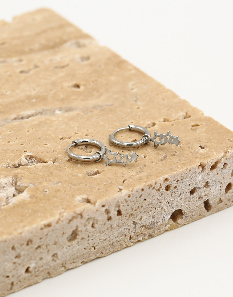 Silver-colored star earrings