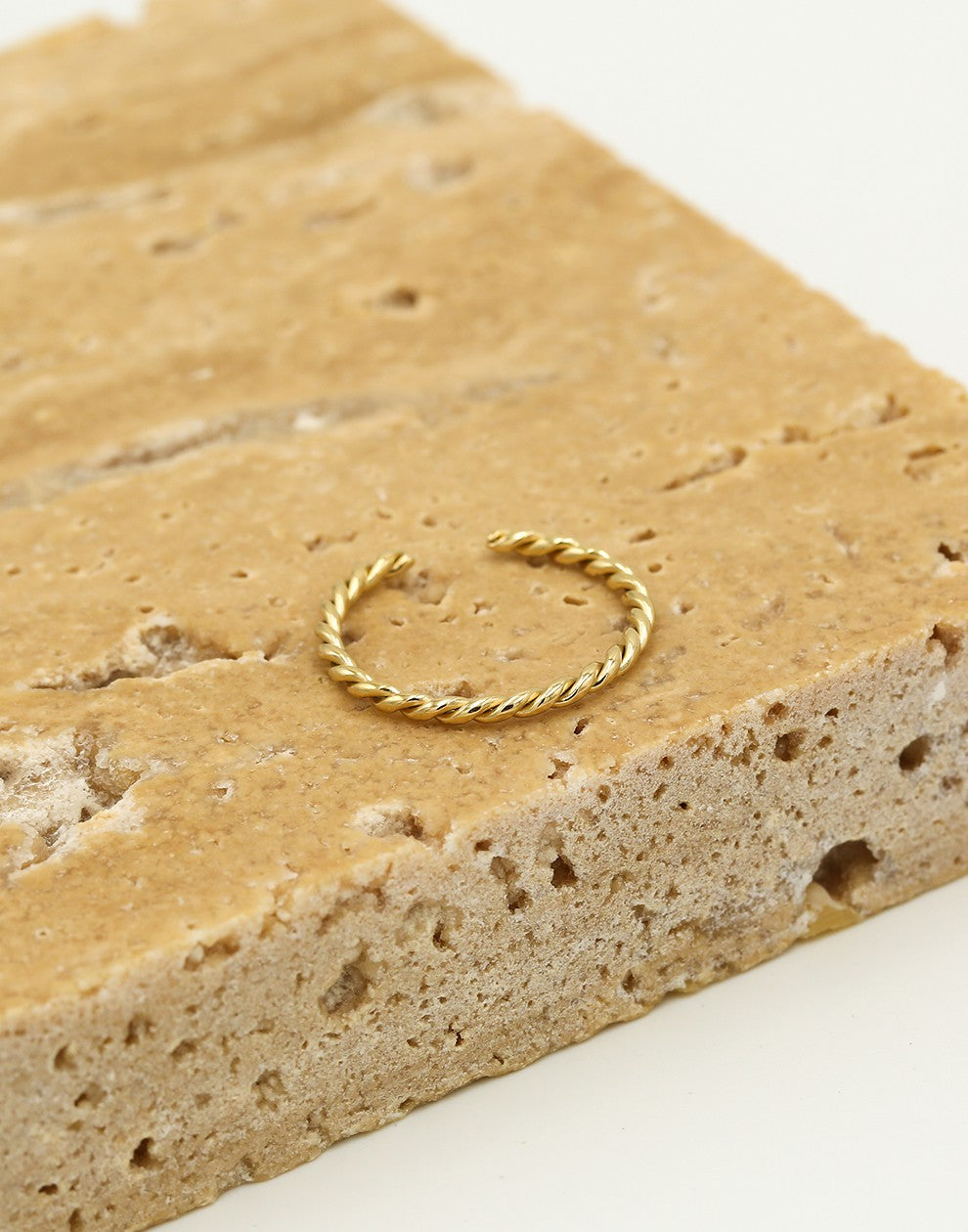 Twisted gold-colored ring