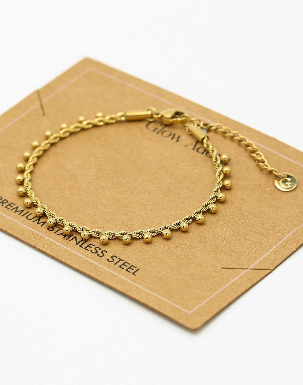 Gedraaide armband bolletjes goudkleurig
