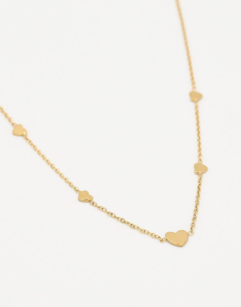 gold-colored heart necklace
