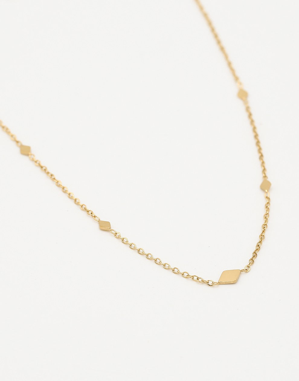 gold-colored diamond necklace