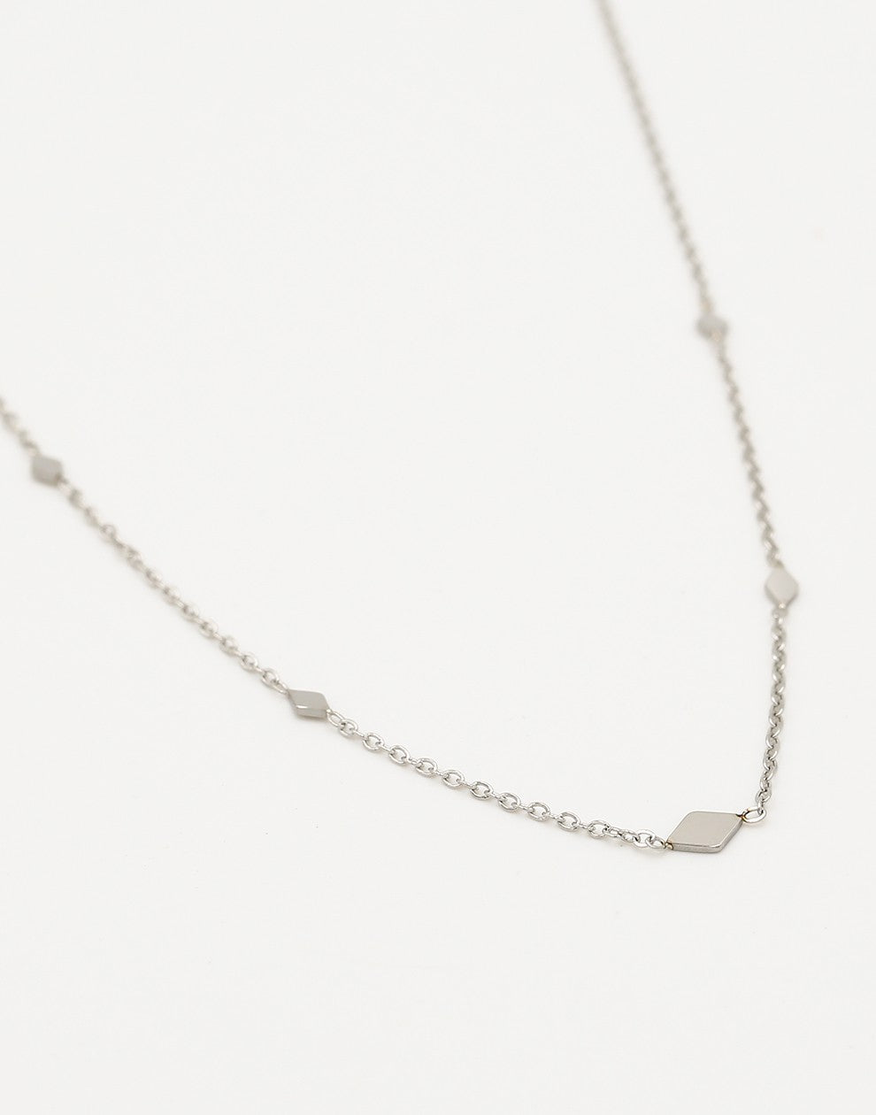 silver-colored diamond necklace