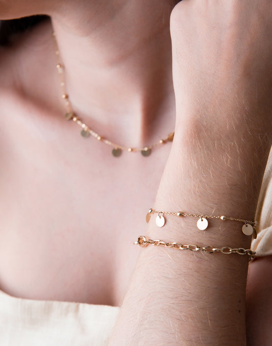 Bead bracelet with gold-colored coins