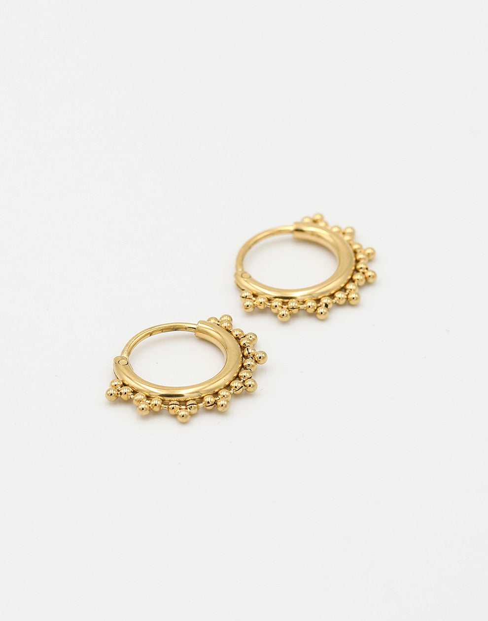 gold-colored hoop earrings