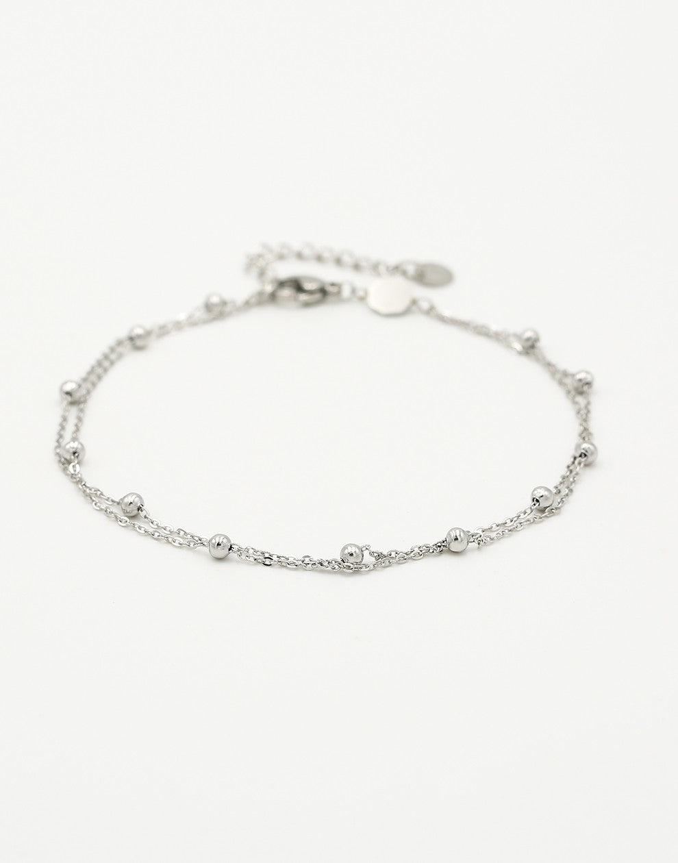 Ankle bracelet with double silver-colored beads and chains