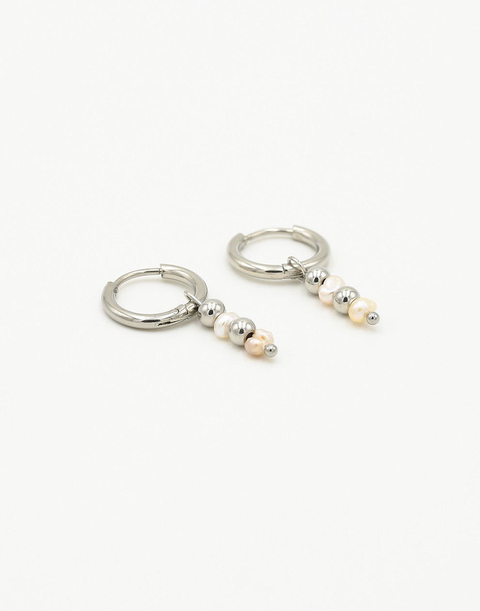 silver-colored ball and pearl earrings
