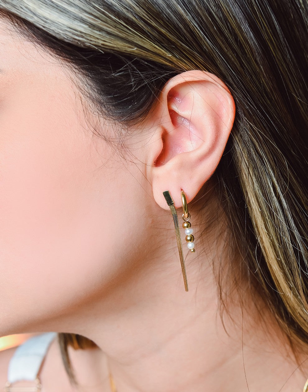 gold-colored ball and pearl earrings