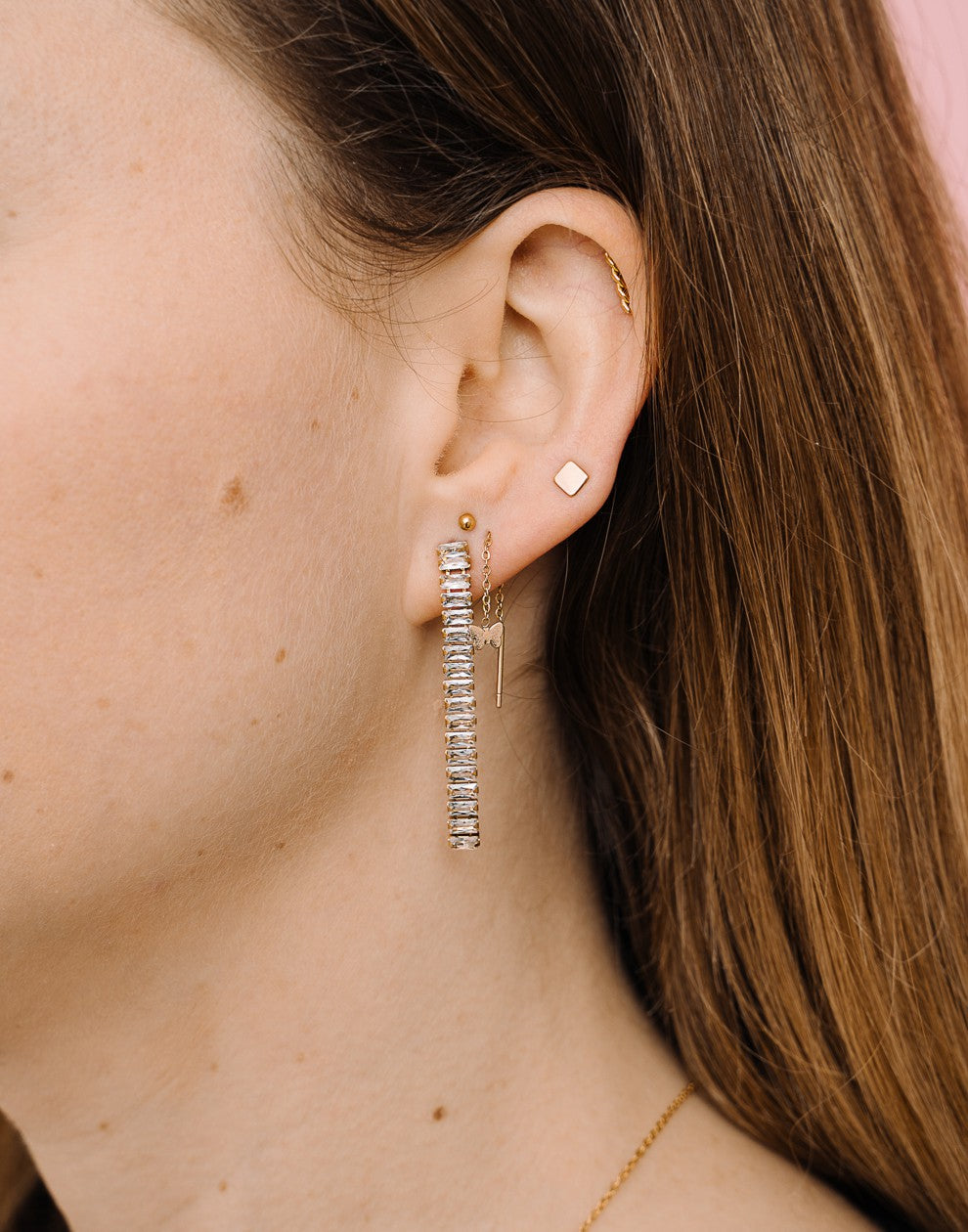 gold-colored butterfly pull-through earrings
