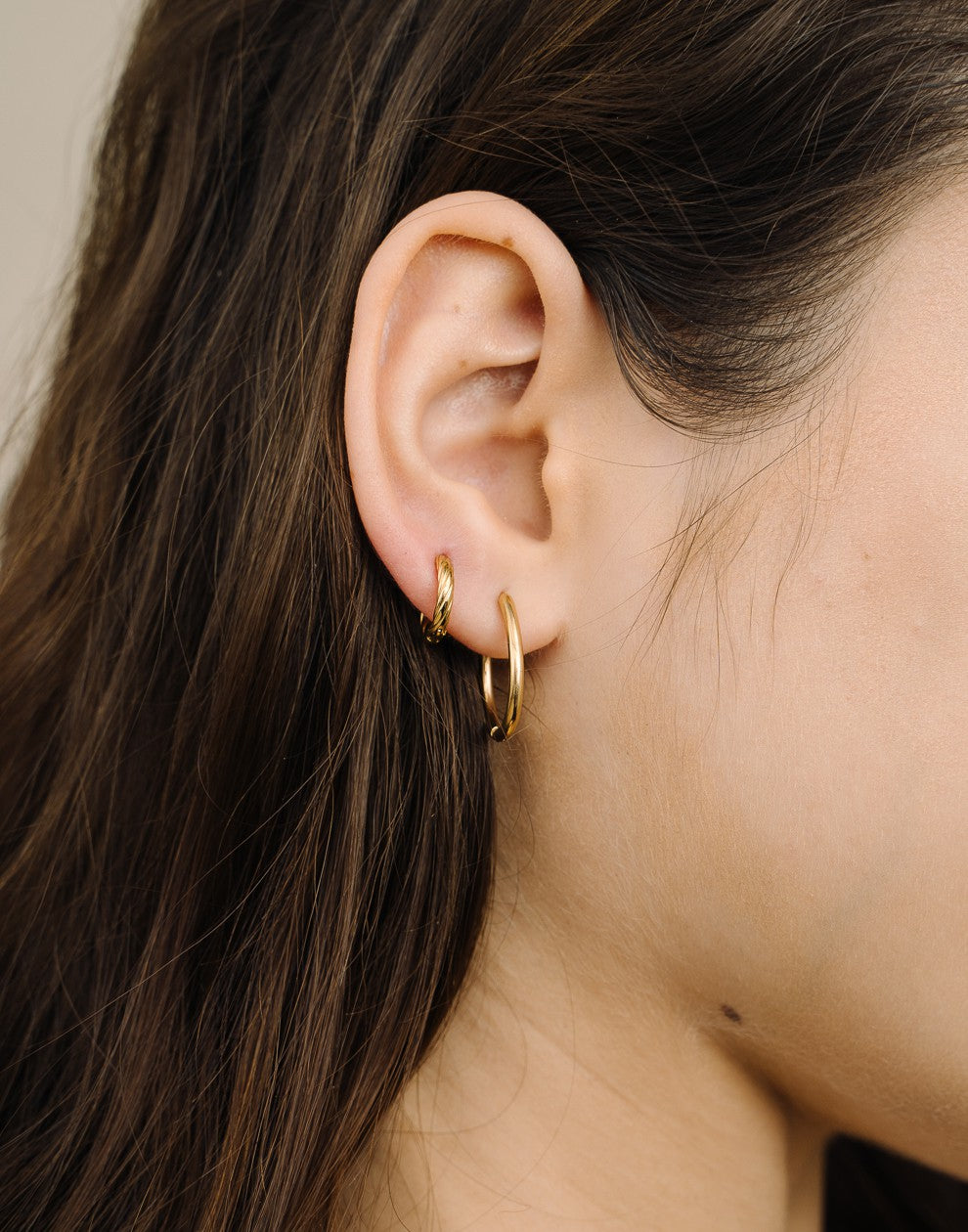 gold-colored twisted hoop earrings