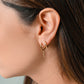 gold-colored twisted hoop earrings
