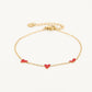 Armband speels hartjes rood goudkleurig