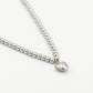silver-colored ball necklace with heart