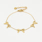 minimalist bracelet with 3 gold-colored bows