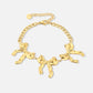 schakelarmband met 3 chunky strikjes goudkleurig