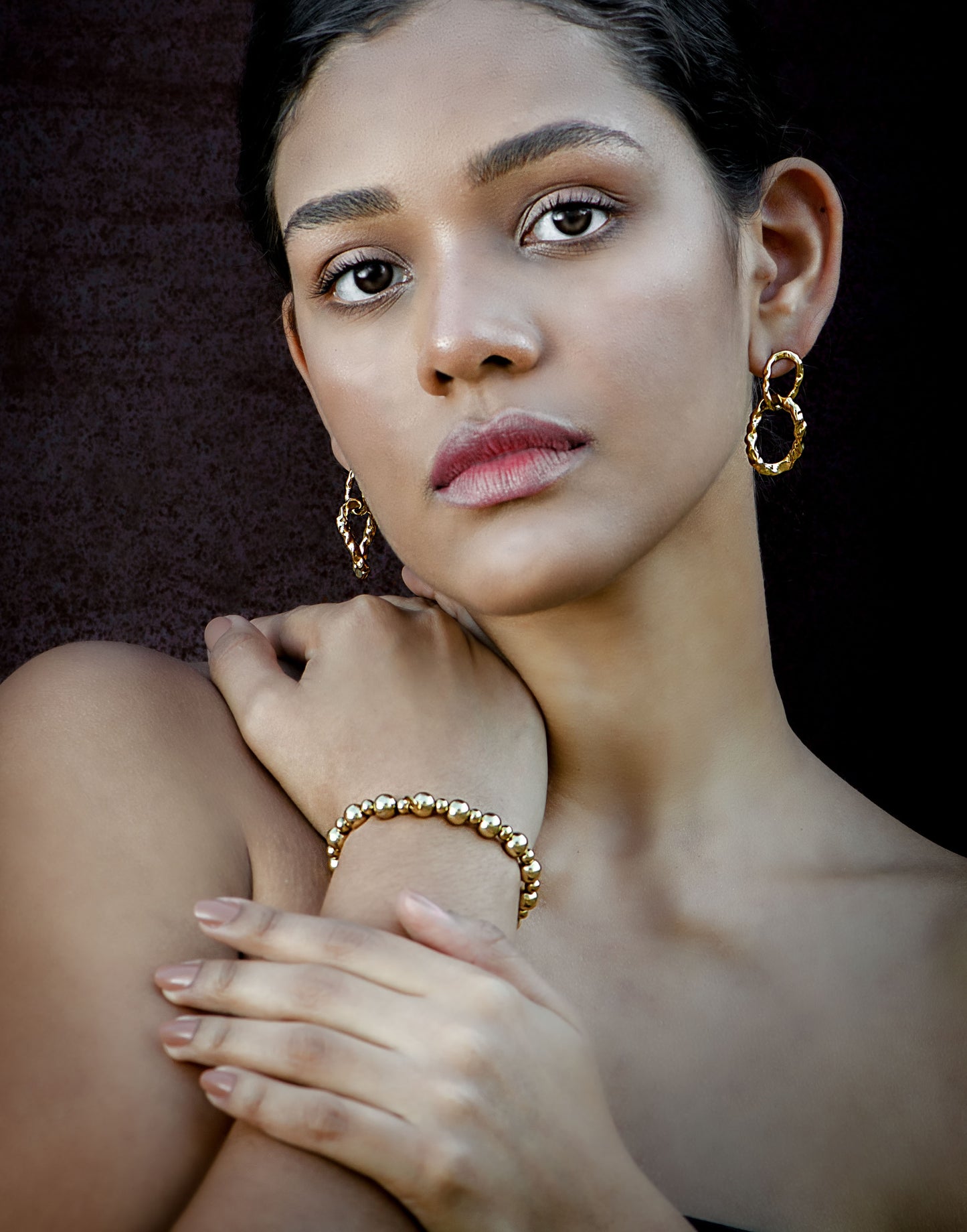 gold-colored link earrings 