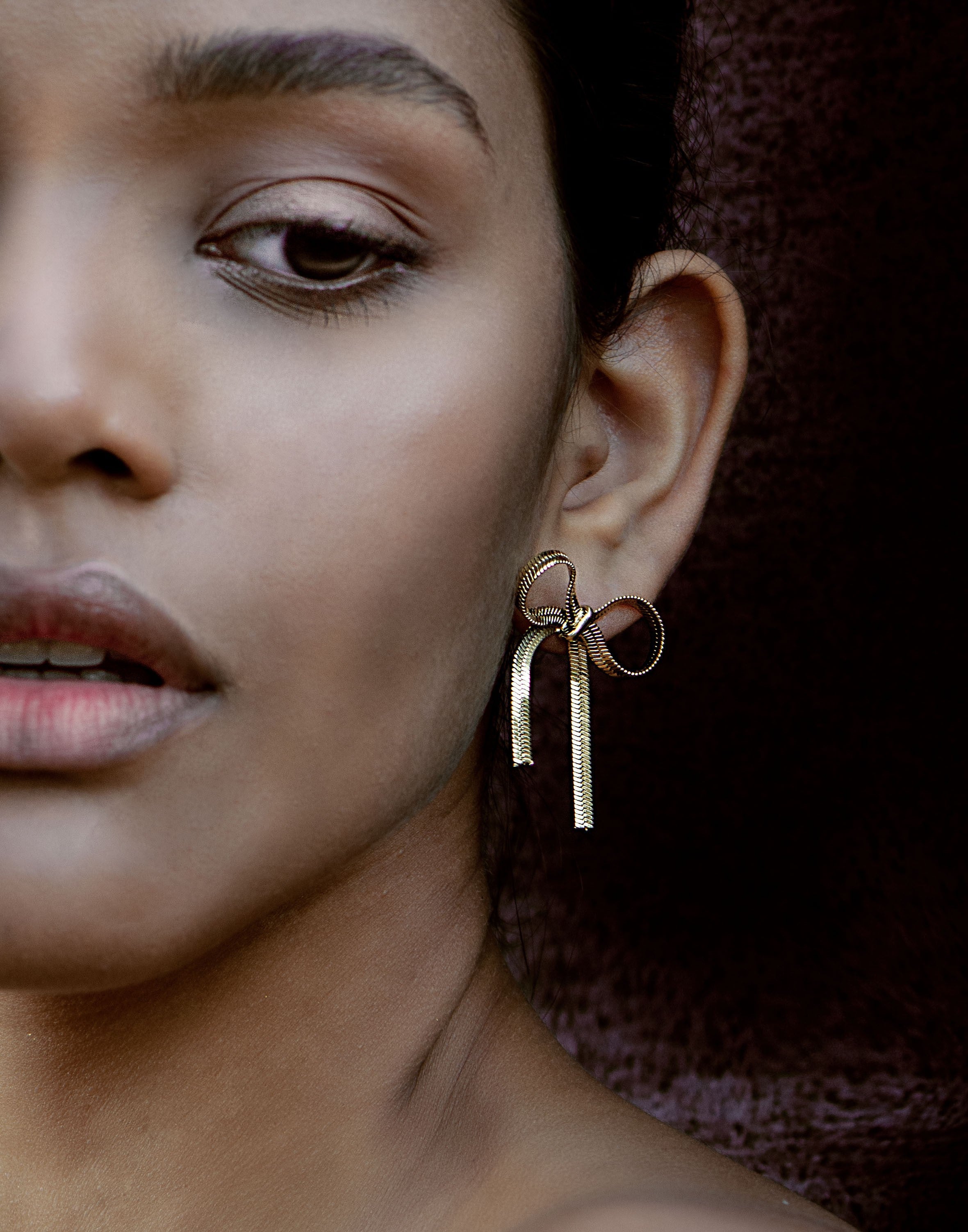 gold-colored bow earrings