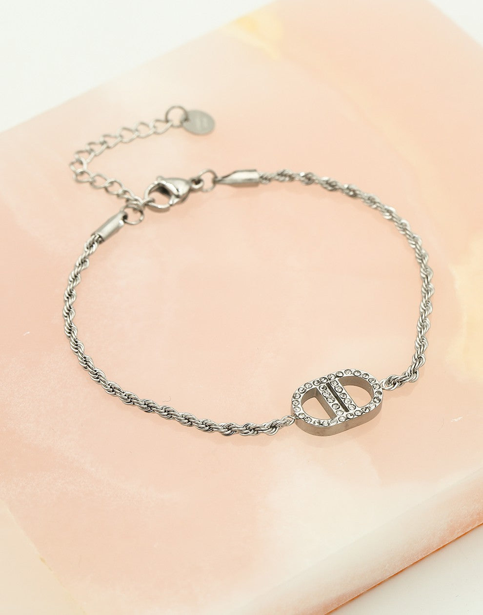 Gedraaide schakelarmband met symbool strass zilverkleurig