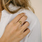 Gold-colored ring with bow