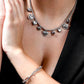 double silver-colored link bracelet