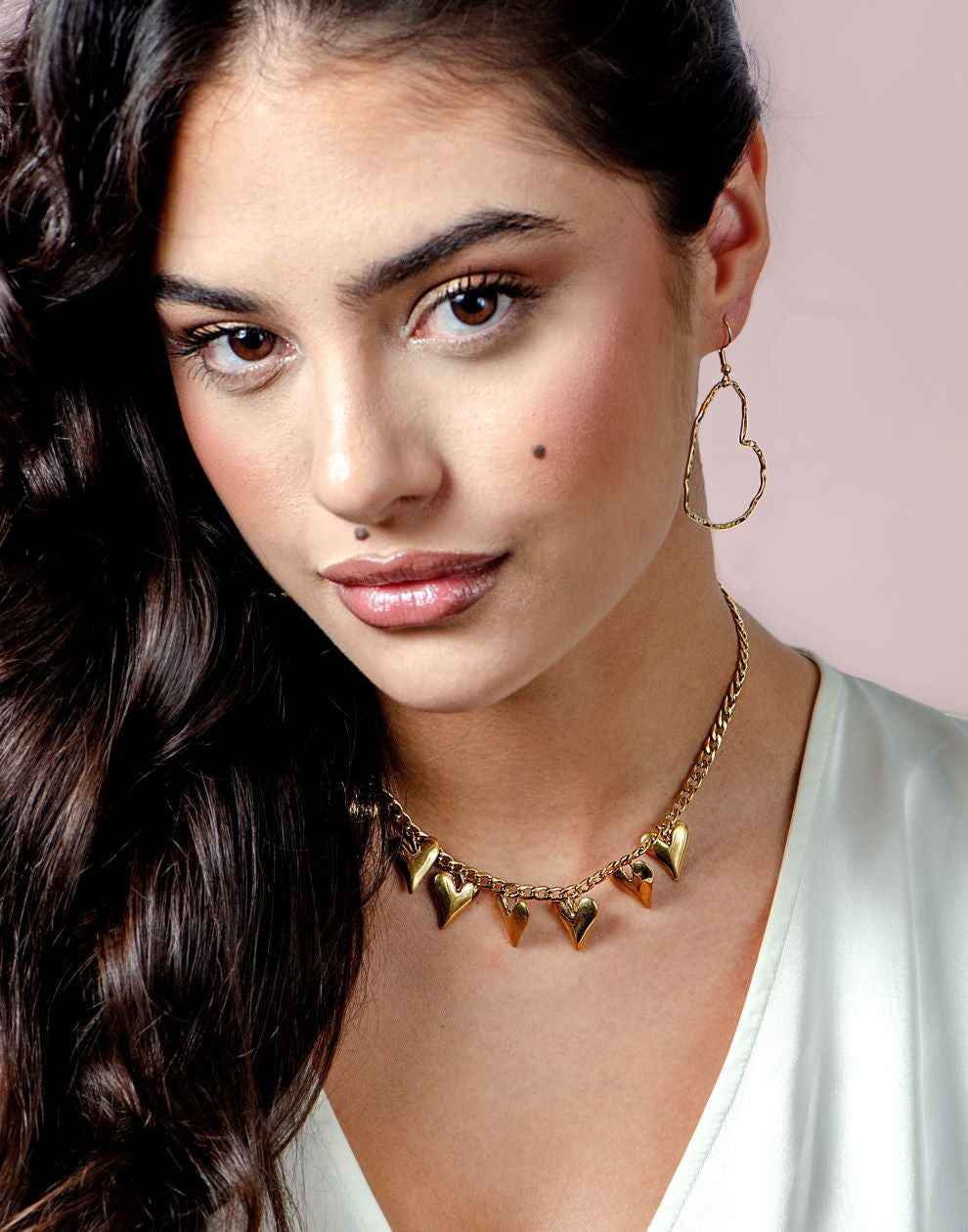 gold-colored open heart earrings