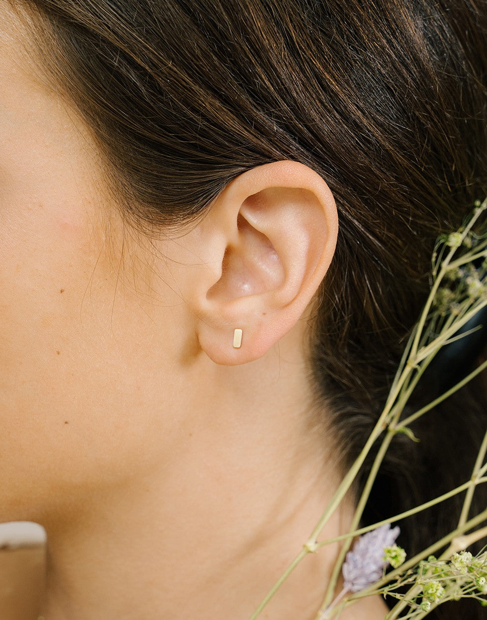 Gold-colored stud bar