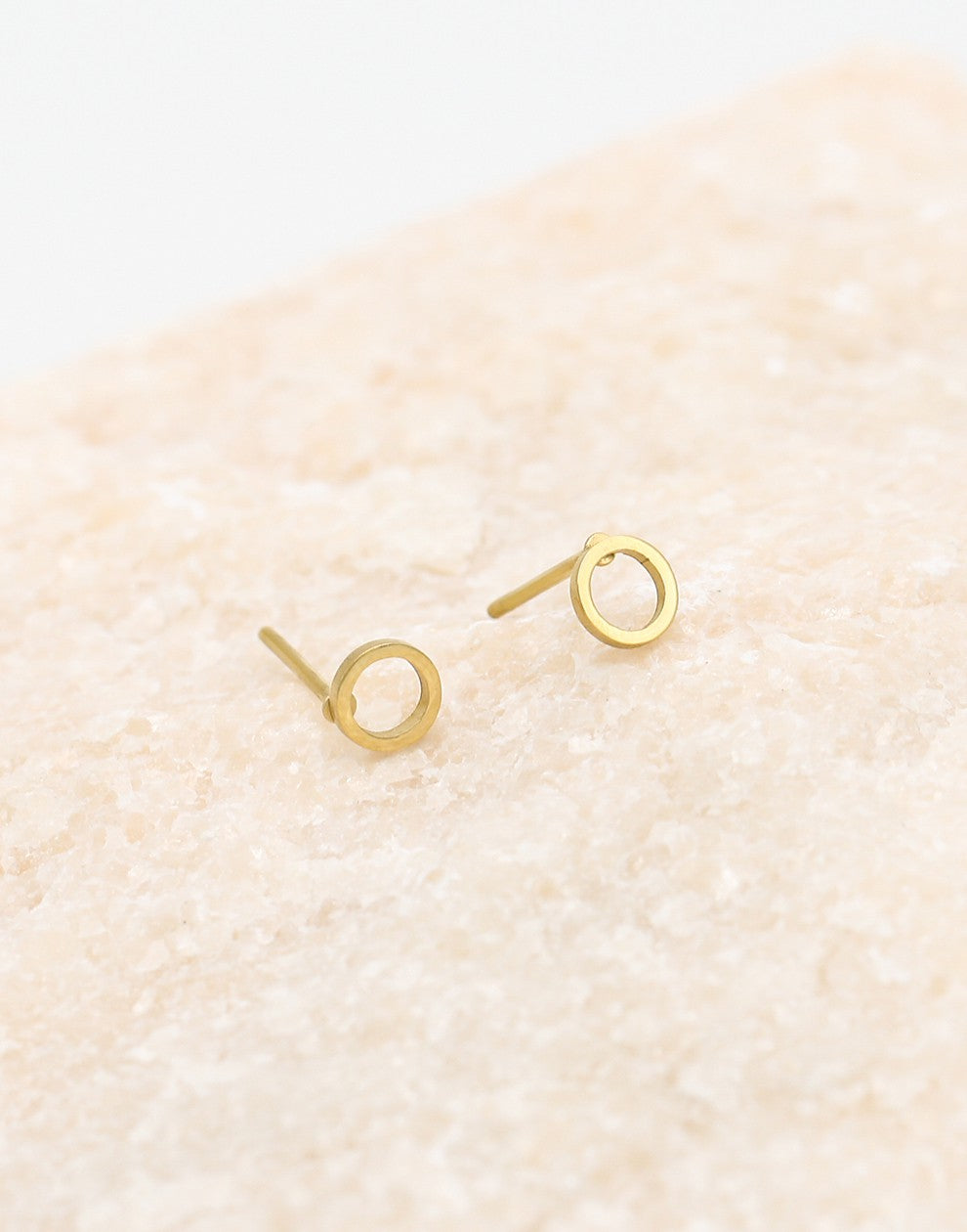 Open circle gold-colored earring