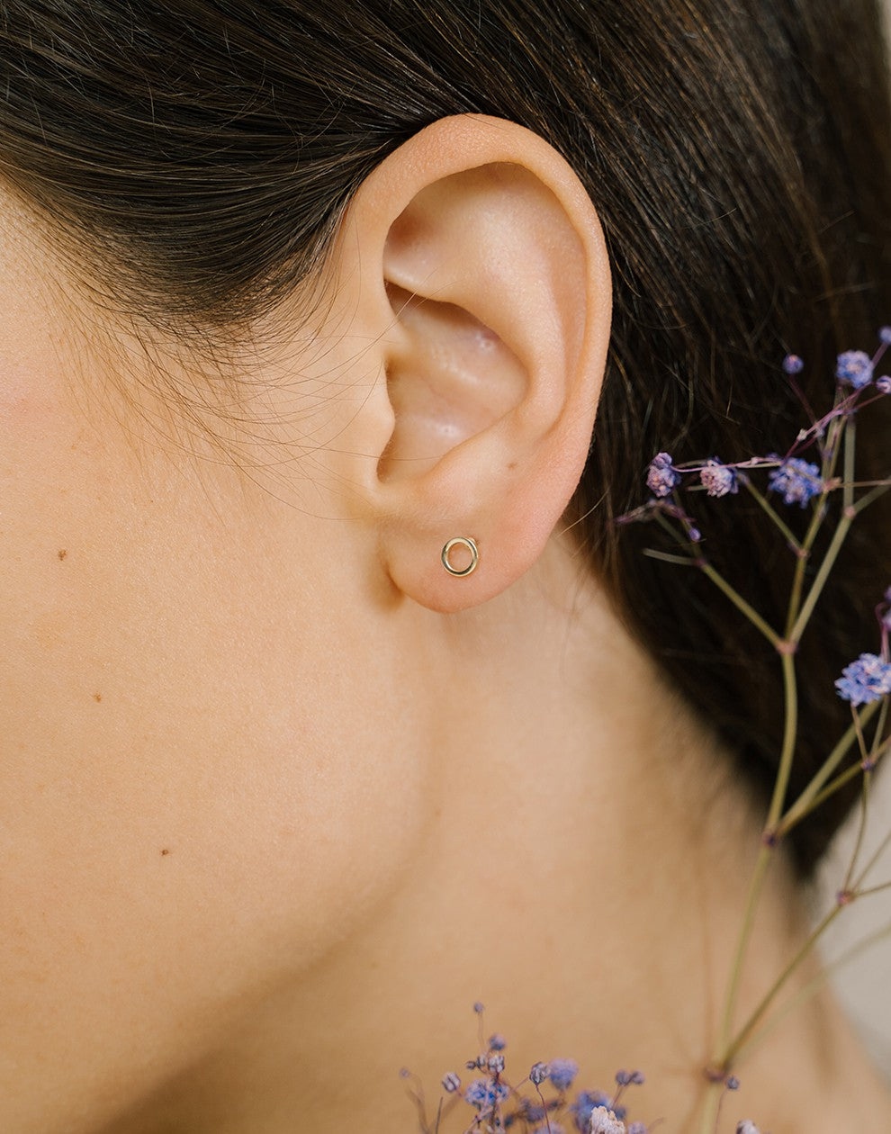 Open circle gold-colored earring