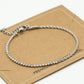 Armband tennis en gedraaide schakel zilverkleurig