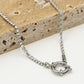 Twisted link necklace with stones and silver-colored clasp