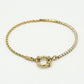 Armband gedraaide schakel met steentjes goudkleurig