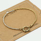 Armband gedraaide schakel met steentjes goudkleurig