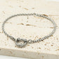 Armband gedraaide schakel met steentjes zilverkleurig