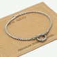 Armband gedraaide schakel met steentjes zilverkleurig