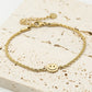 Gedraaide armband smiley goudkleurig