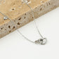 Ketting dubbele hartjes met bedel zilverkleurig