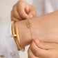 Armband dubbele hartjes met bedel goudkleurig