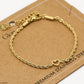 Armband gedraaid met open hartje goudkleurig