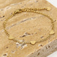Schakelarmband drie hartjes goudkleurig