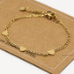 Schakelarmband drie hartjes goudkleurig