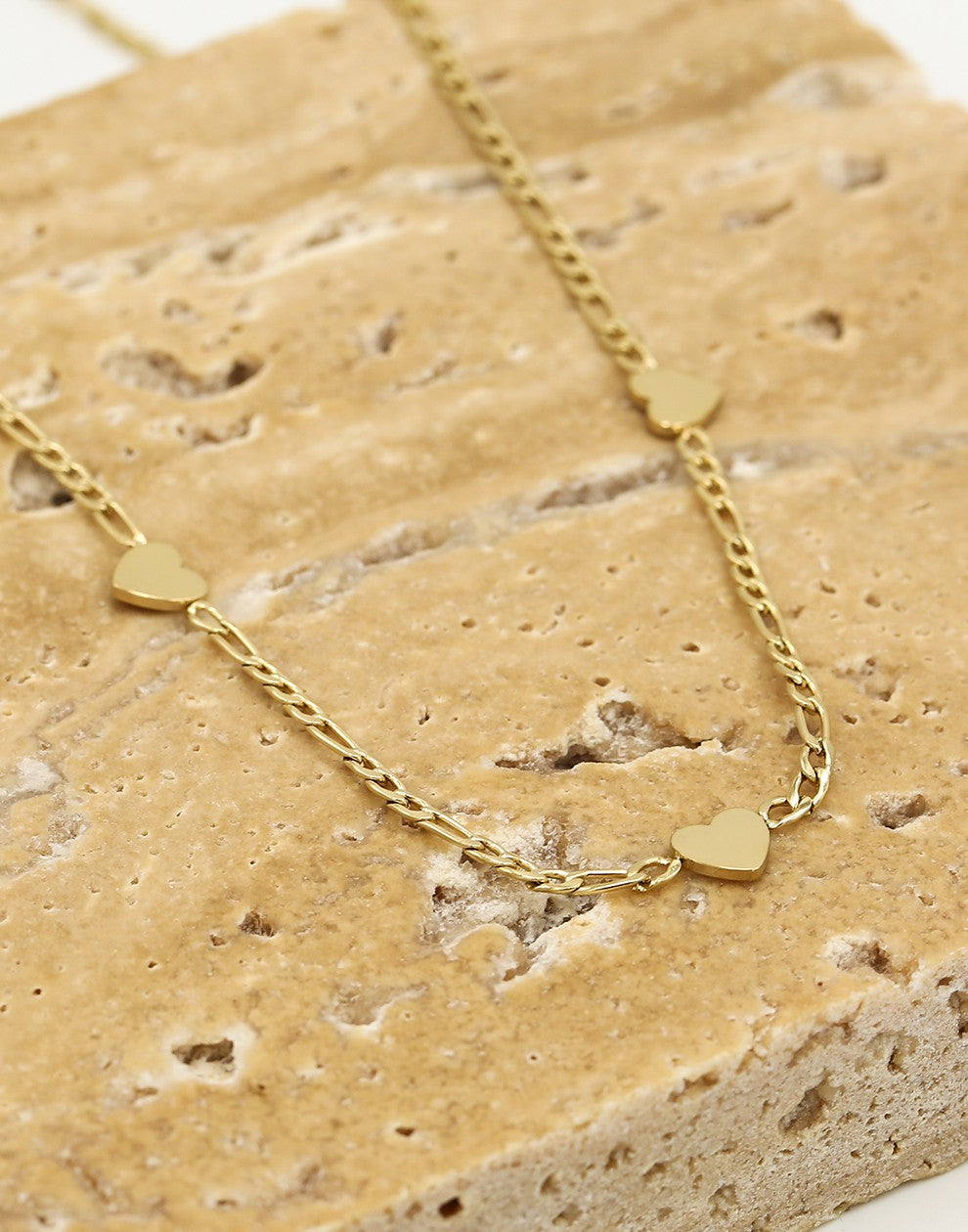 Schakelketting drie hartjes goudkleurig