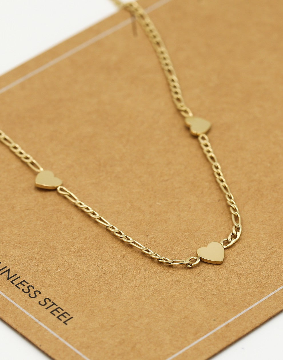 Schakelketting drie hartjes goudkleurig